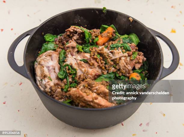 chicken with lentils and spinach in cast iron casserole. - chicken stew stock pictures, royalty-free photos & images