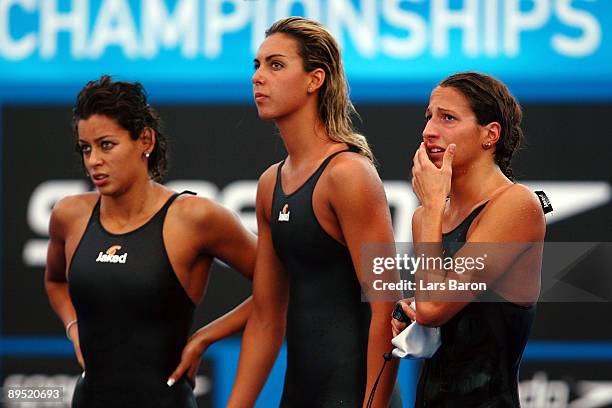 Renata Spagnolo, Alessia Filippi , Alice Carpanese watch Federica Pellegrini of Italy in the Women's 4x 200m Freestyle Final during the 13th FINA...