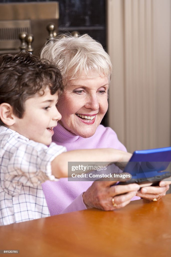 Grandma playing video game with grandson