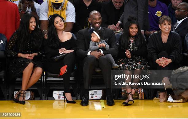 Los Angeles Lakers legend Kobe Bryant seated courtside with his family looks on during a basketball game between the Golden State Warriors and Los...