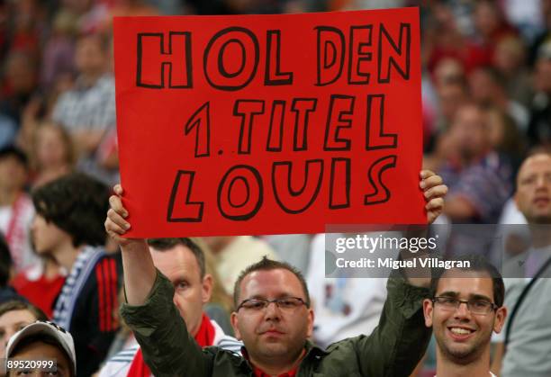 Supporter of Bayern Muenchen holds a poster reading 'Louis get the first title' during the Audi Cup tournament match between FC Bayern Muenchen v...