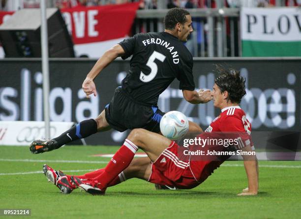 Mario Gomez of Bayern and Rio Ferdinand of Manchester fight for the ball during the Audi Cup tournament final match FC Bayern Muenchen v Manchester...