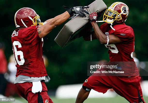 Eddie Williams and running back Anthony Aldridge of the Washington Redskins practice during drills on opening day of training camp July 30, 2009 in...