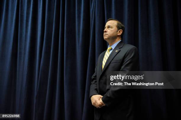 Athletic Director, Patrick Nero listens during a press conference to announce, Mike Lonergan as the new head coach for the George Washington...