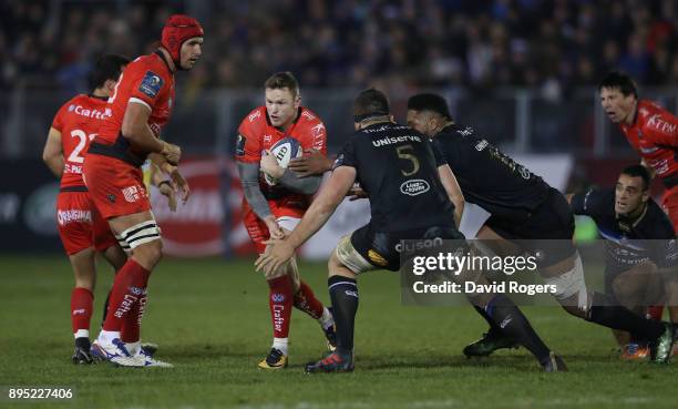 Chris Ashton of Toulon is tackled during the European Rugby Champions Cup match between Bath Rugby and RC Toulon at the Recreation Ground on December...