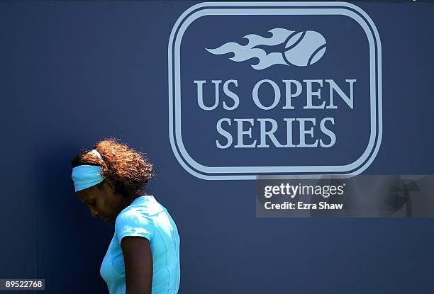 Serena Williams of the USA tries to stay cool in the shade from the wall on the court during her match against Melinda Czink of Hungary on Day 4 of...