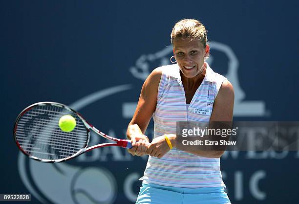 Melinda Czink of Hungary returns a shot to Serena Williams of the USA during their match on Day 4 of the Bank of the West Classic at Stanford...