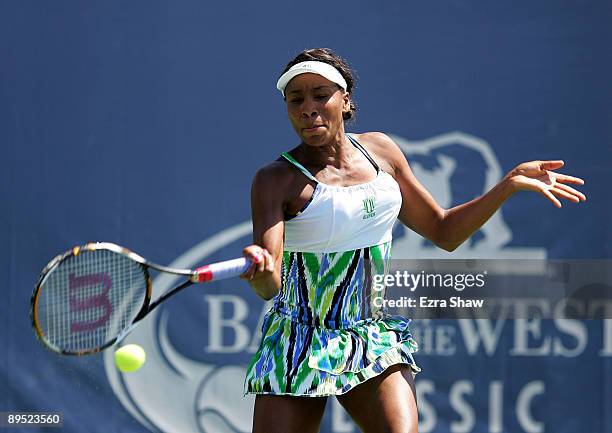 Venus Williams of the USA returns a shot to Alla Kudryavtseva of Russia during their match on Day 4 of the Bank of the West Classic at Stanford...