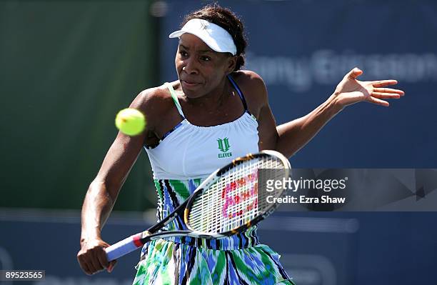 Venus Williams of the USA returns a shot to Alla Kudryavtseva of Russia during their match on Day 4 of the Bank of the West Classic at Stanford...