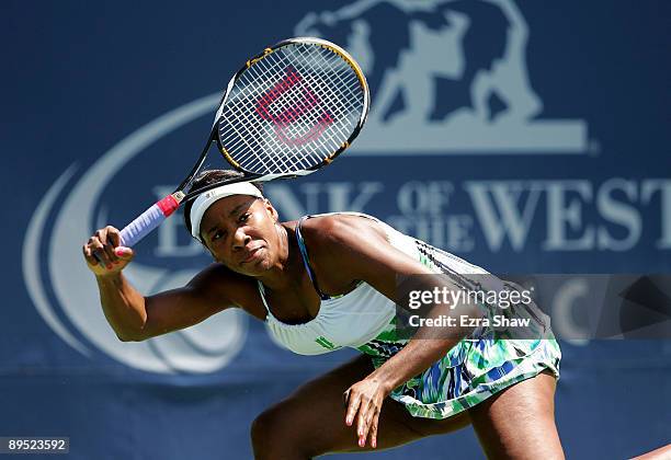 Venus Williams of the USA returns a shot to Alla Kudryavtseva of Russia during their match on Day 4 of the Bank of the West Classic at Stanford...