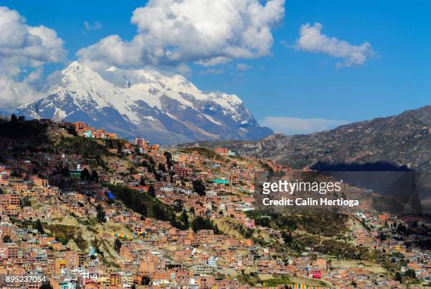dense neighborhood of la paz with mount illimani in the backdrop - la paz bolivia stock pictures, royalty-free photos & images