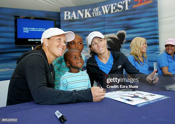 Cara Black of Zimbabwe and Liezel Huber of USA pose for a picture while signing autographs on Day 4 of the Bank of the West Classic at Stanford...