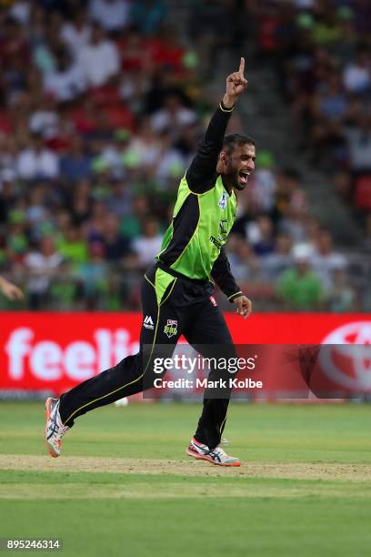 Fawad Ahmed of the Thunder celebrates taking the wicket of Nic Maddinson of the Sixers during the Big Bash League match between the Sydney Thunder...