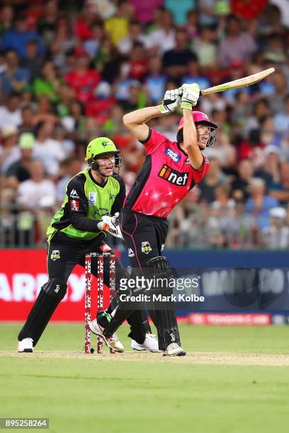 Jos Buttler of the Thunder watches on as Johan Botha of the Sixers bats during the Big Bash League match between the Sydney Thunder and the Sydney...