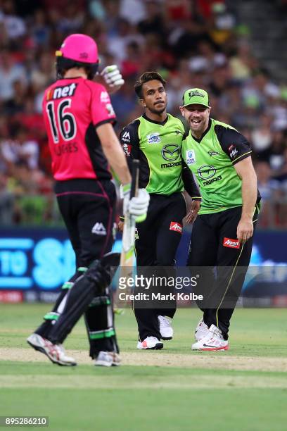Arjun Nair and Aiden Blizzard of the Thunder celebrate the wicket of Moises Henriques of the Sixers during the Big Bash League match between the...