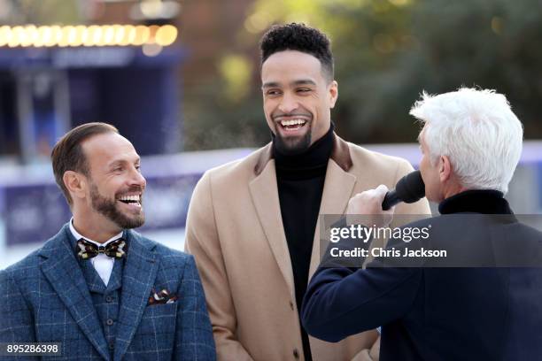 Presenter Phillip Schofield interviews judges Jason Gardiner and Ashley Banjo during the Dancing On Ice 2018 photocall held at Natural History Museum...