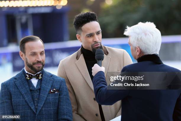 Presenter Phillip Schofield interviews judges Jason Gardiner and Ashley Banjo during the Dancing On Ice 2018 photocall held at Natural History Museum...