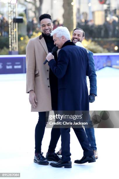 Presenter Phillip Schofield interviews judges Jason Gardiner and Ashley Banjo during the Dancing On Ice 2018 photocall held at Natural History Museum...