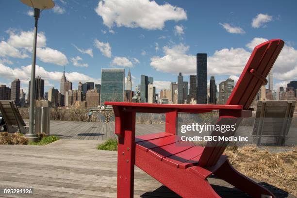 red chair with view of nyc skyline - long island city stock pictures, royalty-free photos & images