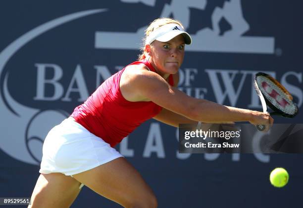 Melanie Oudin of the USA returns a shot to Marion Bartoli of France during their match on Day 4 of the Bank of the West Classic at Stanford...