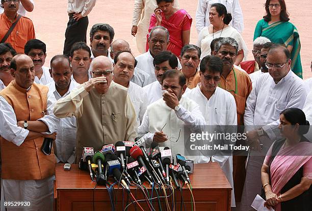Bharatiya Janata Party leader L.K. Advani, center, speaks to the media surrounded by lawmaker allies of the National Democratic Alliance , after...