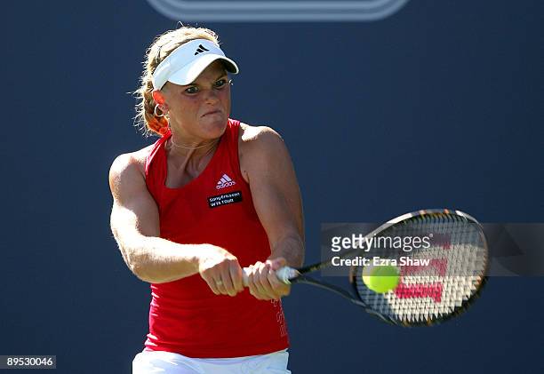 Melanie Oudin of the USA returns a shot to Marion Bartoli of France during their match on Day 4 of the Bank of the West Classic at Stanford...