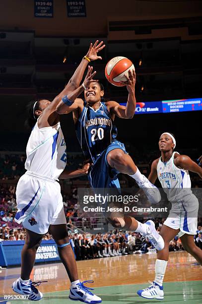 Alana Beard of the Washington Mystics goes up for a shot against Ashley Battle of the New York Liberty on July 30, 2009 at Madison Square Garden in...