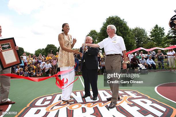 Candace Parker, Naperville Mayor A. George Pradel, and Naperville Park District Board President Mike Reilly receives a jumper for her daughter from...