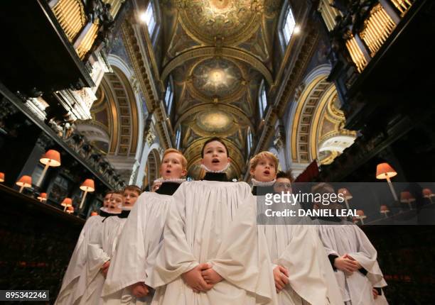 Choristers sing during a rehearsal for their upcoming Christmas performances, at St Paul's Cathedral in central London on December 19, 2017.