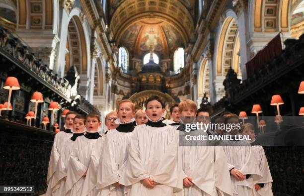 Choristers sing during a rehearsal for their upcoming Christmas performances, at St Paul's Cathedral in central London on December 19, 2017.