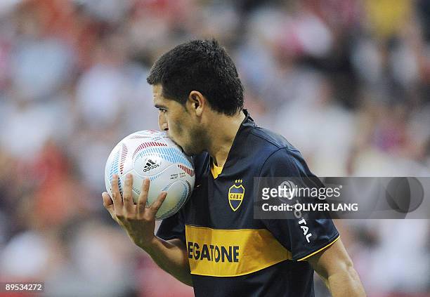 Boca Juniors' midfielder Juan Riquelme kisses the ball during the match for third place of the "Audi Cup" AC Milan vs Boca Juniors in the southern...