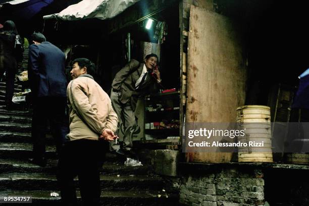 People walking in the old city, Chongqing. The city of Chongqing is one of the fastest-growing urban centres on the planet. It is changing...