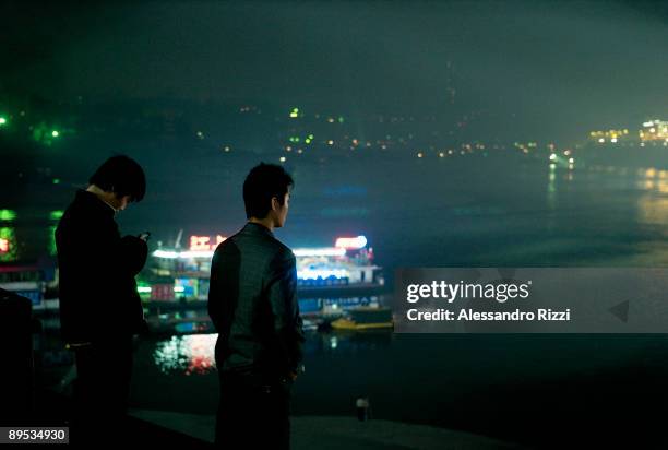 People watching the night lights show along the Yangtze River, in Chongqing. The city of Chongqing is one of the fastest-growing urban centres on the...