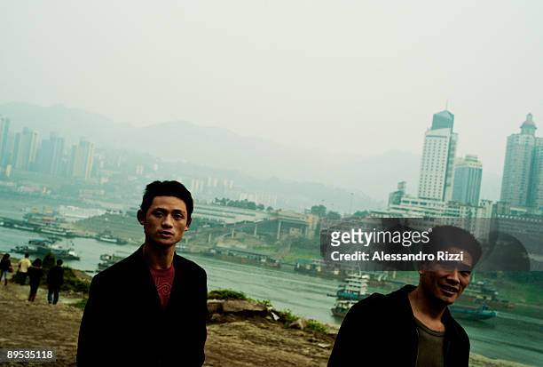 Two workers walking near the Yangtze River, in CHongqing. The city of Chongqing is one of the fastest-growing urban centres on the planet. It is...