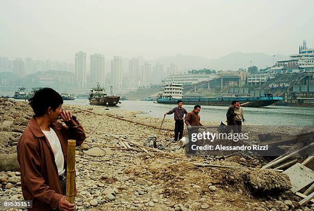 Local workers on the banks of the Jialing River, in Chongqing. The city of Chongqing is one of the fastest-growing urban centres on the planet. It is...