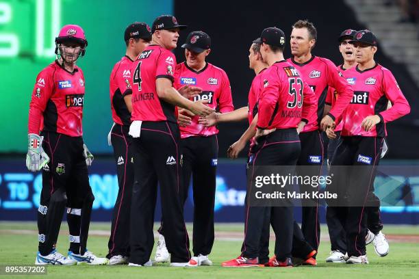 Johan Botha of the Sixers celebrates with his team after taking the wicket of Ben Rohrer of the Thunder during the Big Bash League match between the...