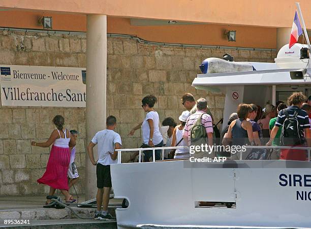 Passengers of a cruise boat "Voyager of the seas" leave a shuttle boat in Villefranche-sur-Mer, southern France after at least 60 crew members of the...
