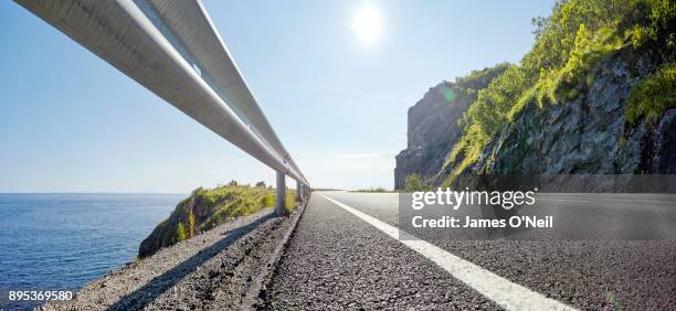 low angle view of empty road panormaic - crash barrier stock pictures, royalty-free photos & images