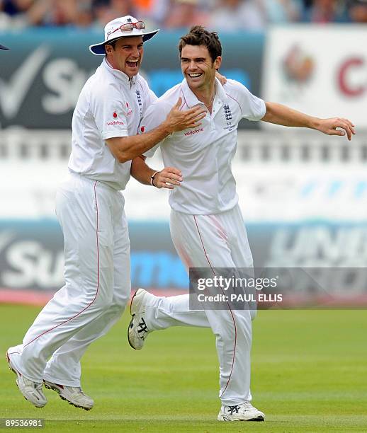 England bowler James Anderson celebrates with captain Andrew Strauss after dismissing Australian batsman Marcus North on the second day of the third...