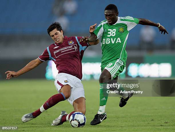 Bryan of Beijing is tackled by James Tomkins of West Ham during the Barclays Asia Trophy 2009 3rd 4th playoff between Beijing Guo'an and West Ham...