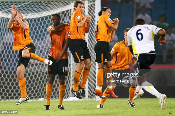 Players of Hull City jump in the wall as Tom Huddlestone of Tottenham strikes a freekick during the Barclays Asia Trophy pre-season friendly match...