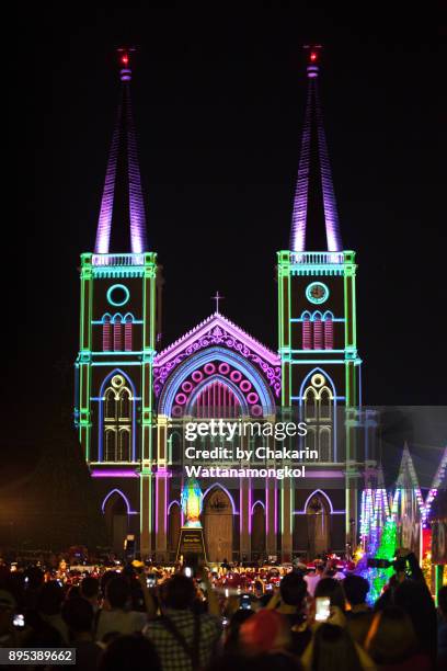 christmas stalls with colorful light in front of the cathedral. - projection mapping stock-fotos und bilder