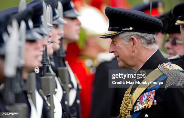 Prince Charles, The Prince of Wales wears the ceremonial dress uniform 'Blues with Sword' of The Queen's Dragoon Guards as he talks with soldiers...