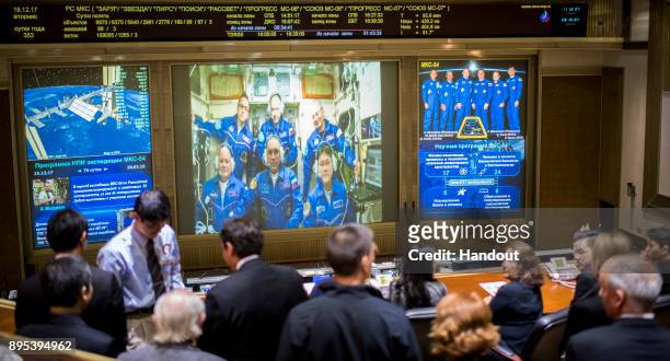 In this handout photo provided by NASA, Expedition 54 flight engineers Scott Tingle of NASA, bottom left, Anton Shkaplerov of Roscosmos, bottom...
