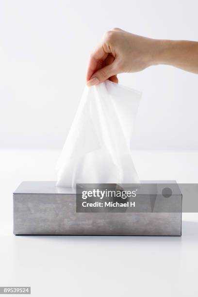 close-up of hand that takes out paper tissue - box of tissues stock pictures, royalty-free photos & images