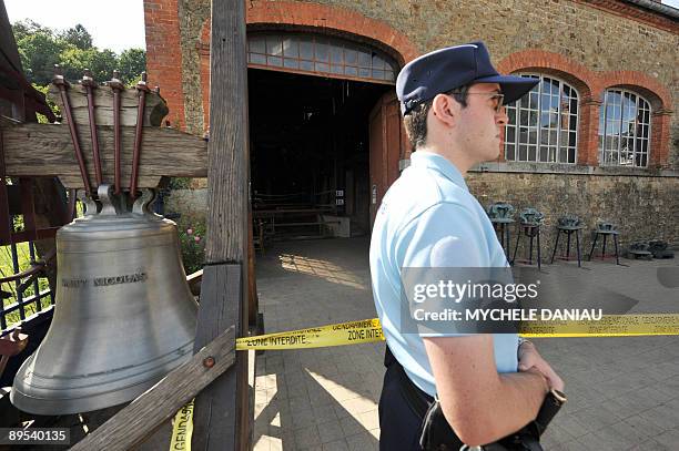 French police officer stands guard in front of a foundry in the Normandy town of Villedieu-les-Poele, on July 31 where forty-six people, invited to...