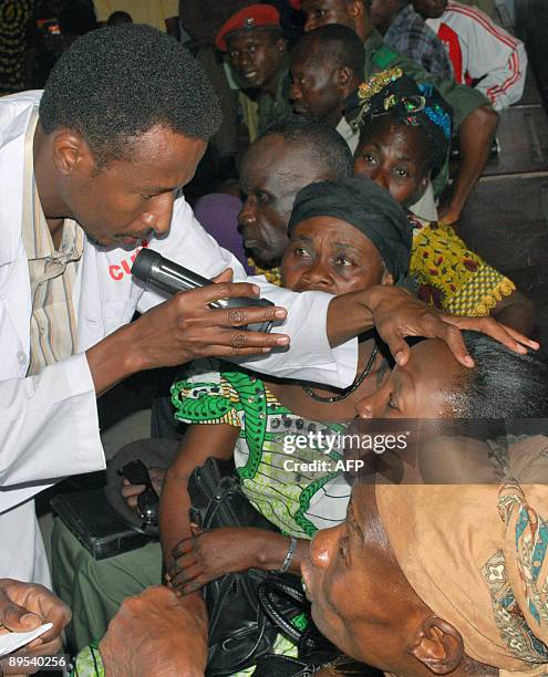 David YOUANT A Sudanese doctor, accompanied by a Congolese Muslim translator, checks-up a 60-year-old woman suffering from cataract at an Islamic...