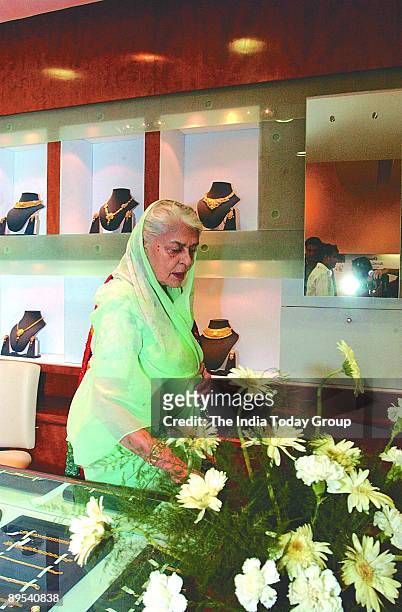 Rajmata Gayatri Devi of Jaipur looks at jewelry in a showroom on October 24, 2002 in New Delhi, India.