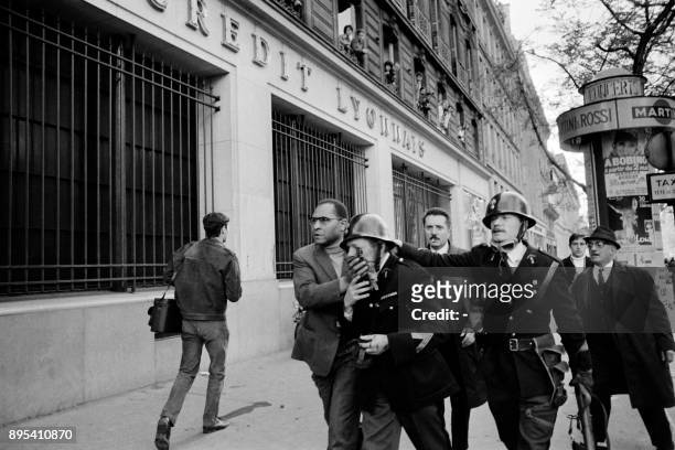 Wounded policeman is helped during clashes with student protesters at the Quartier Latin in May 1968, during the May 1968 events in France.