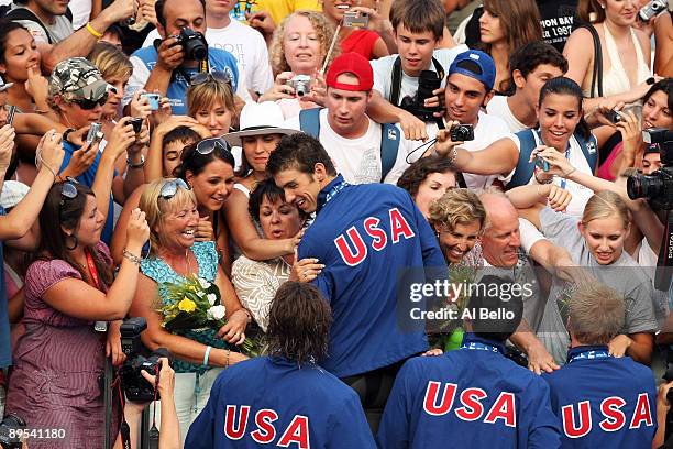 Ryan Lochte, David Walters, Ricky Berens and Michael Phelps of the United States celebrate with family and friends after receiving the gold medal...